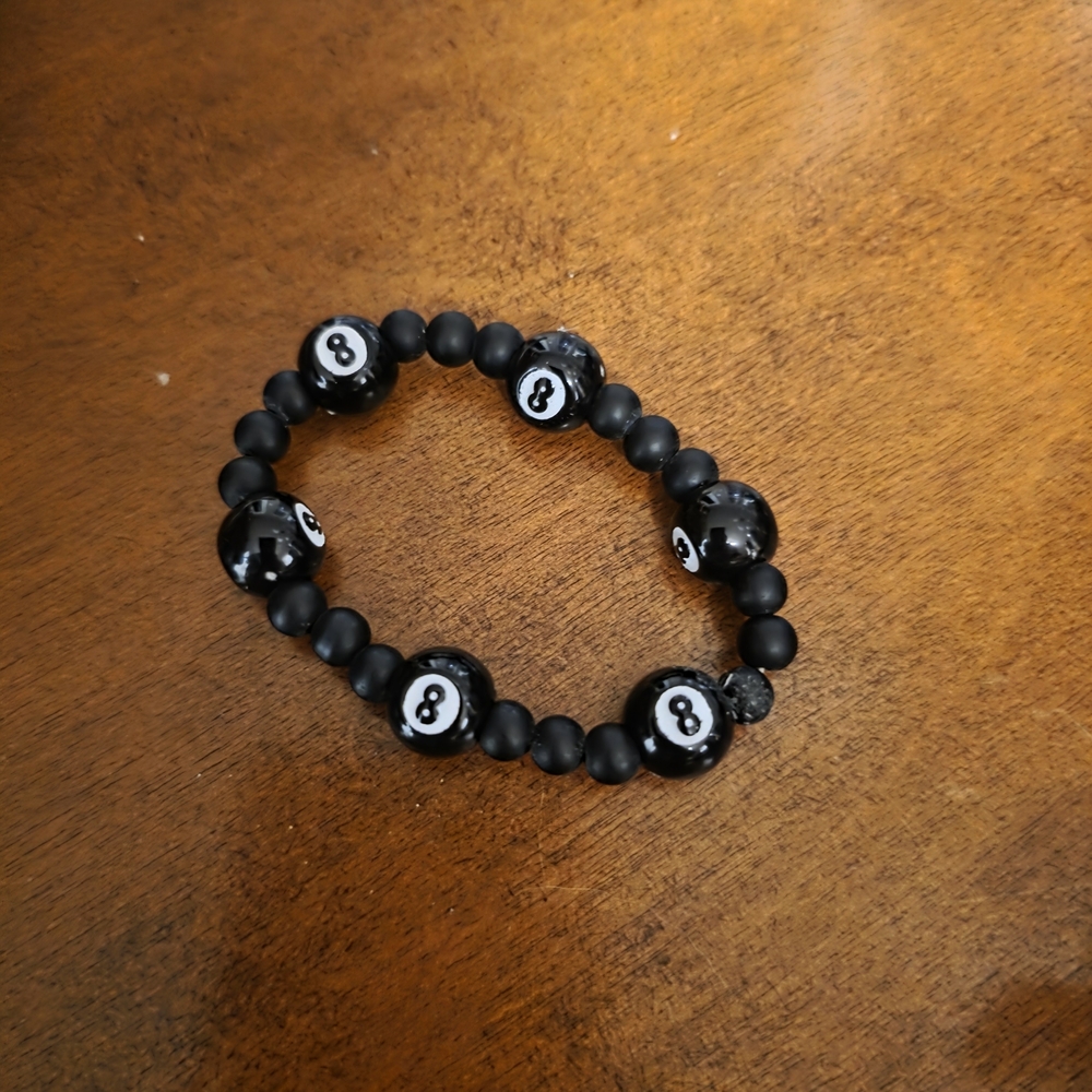 Black beaded bracelet featuring eight 8-ball
